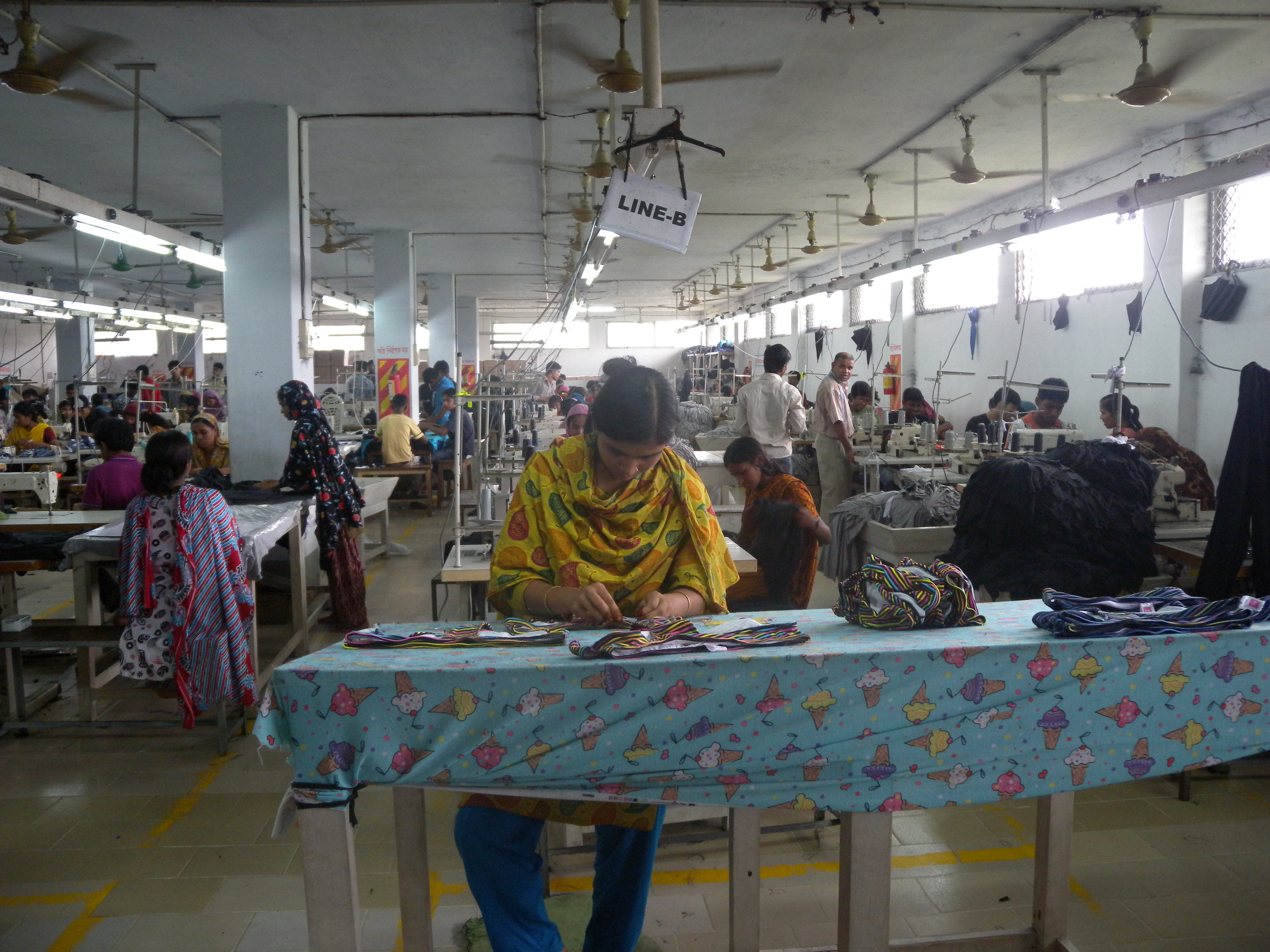 Women and men at sewing lines on a garment factory floor in Bangladesh