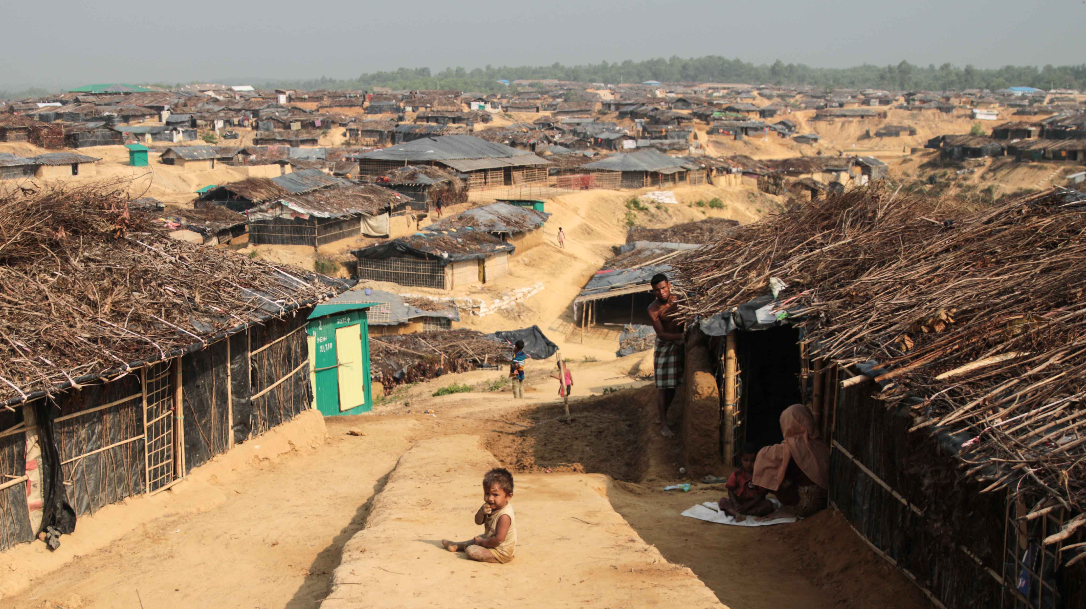 Rows of bamboo and tarpaulin shelters stretching to the horizon in a Rohingya refugee camp