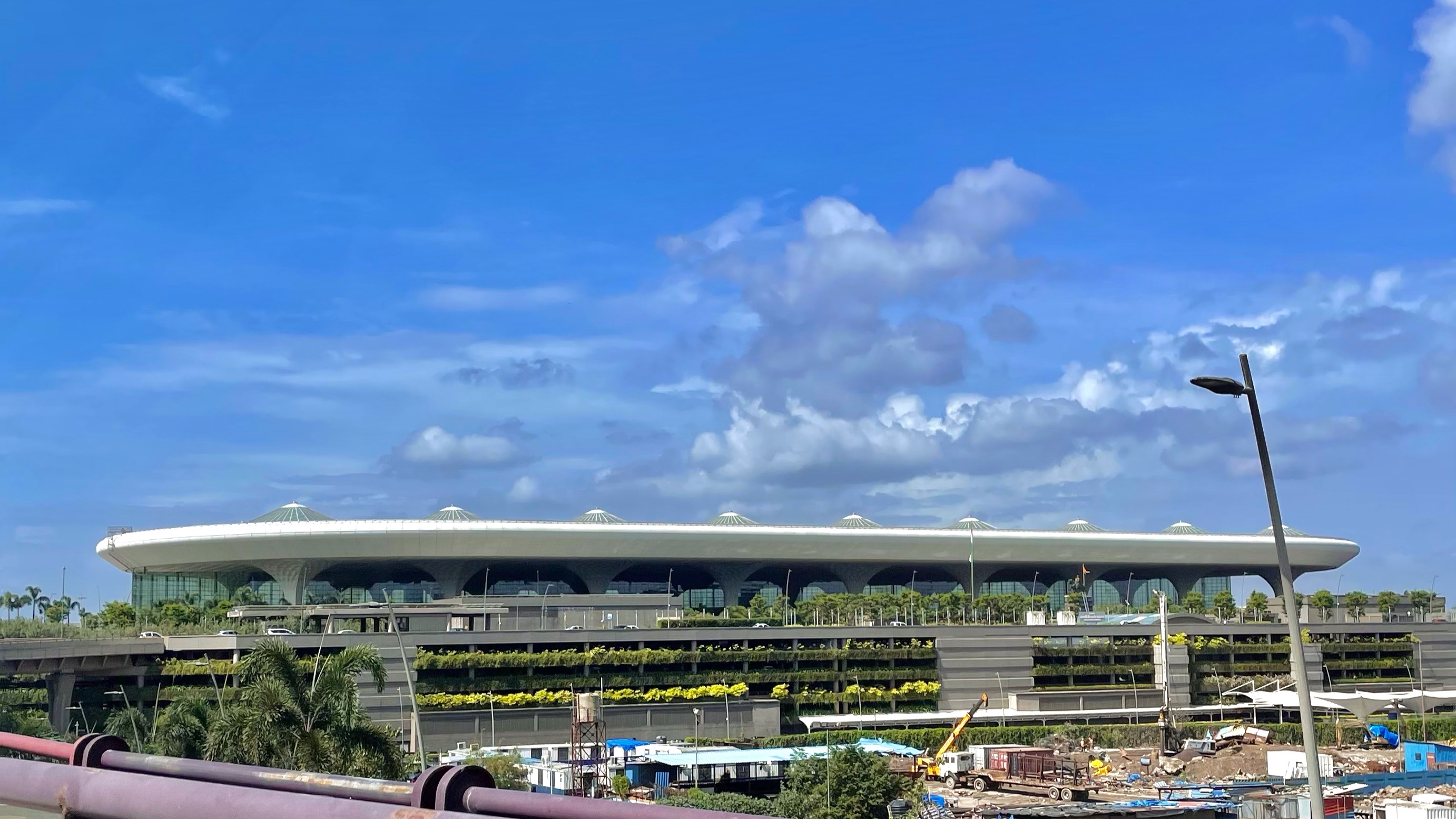 Mumbai airport's international terminal under a blue sky