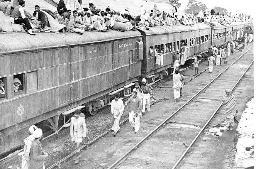 Refugees crowding the roofs and doors of a train in Punjab, 1947